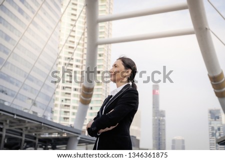 Successful senior caucasian businesswoman leader standing over modern building background
