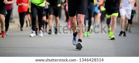 many people at footrace on the road of the city Royalty-Free Stock Photo #1346428514