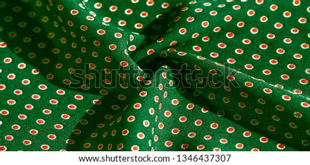 Texture background, pattern,  green silk fabric with red polka dots. Light and silky-soft satin pendant is perfect for your design, online projects. It is also perfect for screensavers and wallpapers