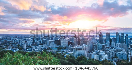 Beautiful sky and sunrise light over Montreal city in the morning time. Amazing view from Mont-Royal with colorful blue architecture. Stunning panorama of Montreal downtown with business buildings.