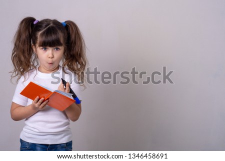 Shocked young girl dreaming and taking notes. 