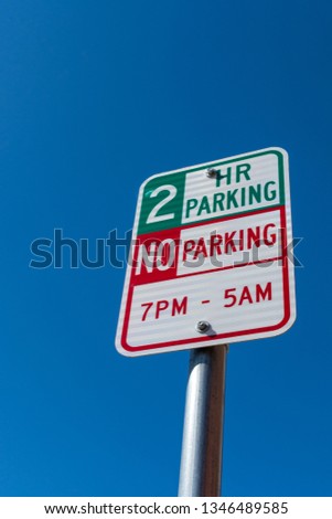 2 hour/two hour parking sign with no parking 7pm till 5am.