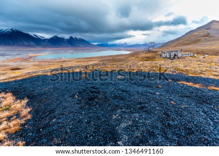 Svalbard mountain landscape with a large old coal spot, green meadows on the svalbard island in late autumn