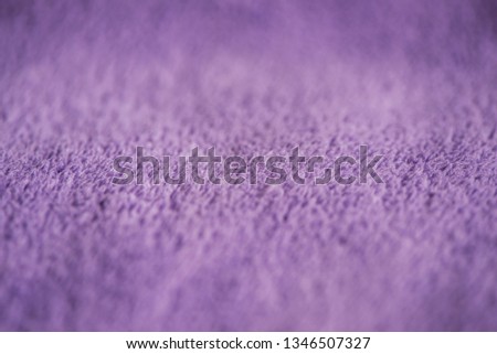 Lilac delicate soft background of fur plush smooth fabric  image. Texture of purple soft fleecy blanket textile photo. Faux fur picture. Soft focus. Shallow depth of field. Copy space.