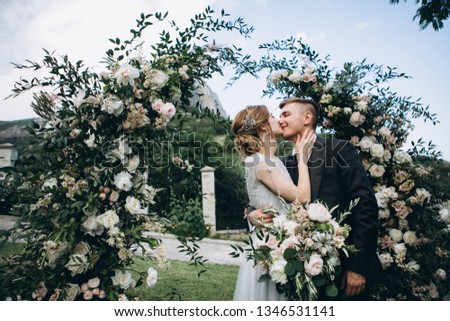 Groom kissing bride on wedding ceremony