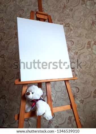 blank canvas on the easel with a polar bear