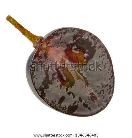 half of black grape isolated on white background