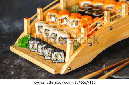 Sushi rolls japanese delicacy. Japanese traditional food from rice and fish. Beautiful serving of food On a dark background with copy space. A set of delicious delicacies. soy sauce