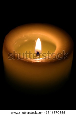 One candle burn flame on black background. Memorial day sorrow symbol. Church candlelight religion concept idea