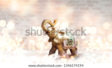 Light background of the room, brick walls, light bokeh, magical atmosphere. Indian elephant on a light background with bokeh.