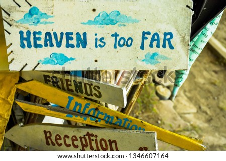 Heaven is too far - handwritten quote painting on a old wooden at Chiang Mai hostel in Thailand for backpackers. 
