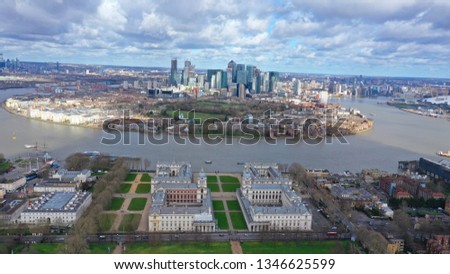 Aerial bird's eye view photo taken by drone of Greenwich park with views to Canary Wharf and University of Greenwich with beautiful cloudy sky, Isle of Dogs, London, United Kingdom