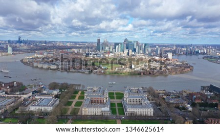 Aerial bird's eye view photo taken by drone of Greenwich park with views to Canary Wharf and University of Greenwich with beautiful cloudy sky, Isle of Dogs, London, United Kingdom