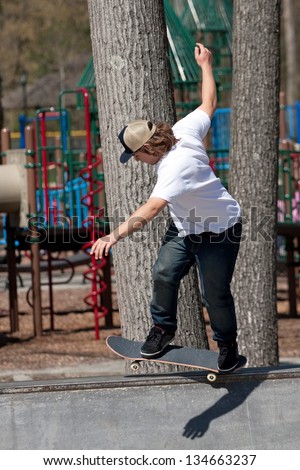 Action shot of a skateboarder skating on a concrete skateboarding ramp at the skate park.