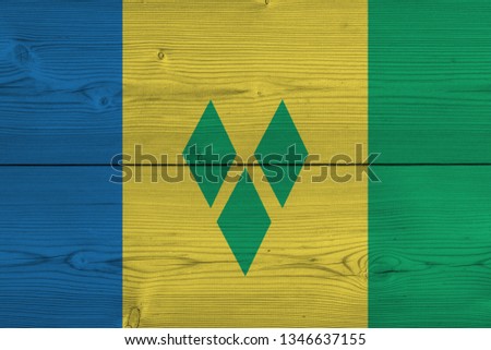 Saint Vincent and the Grenadines flag painted on old wood plank. Patriotic background. National flag of Saint Vincent and the Grenadines