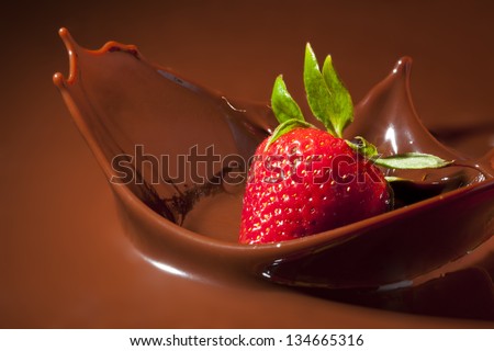 Strawberry Splashing in Milk Chocolate Royalty-Free Stock Photo #134665316