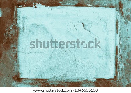 The texture of the old stucco wall with scratches, cracks, dust, crevices, roughness. Can be used as a poster or background for design. Vintage concrete brown frame.
