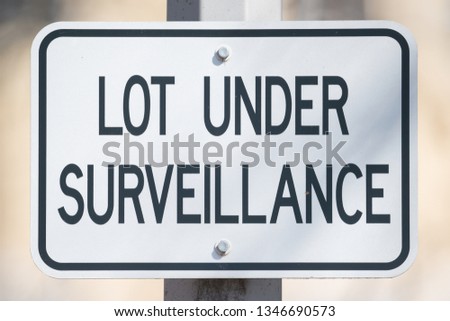 Sign saying 'lot under surveillance' - close up image with great detail