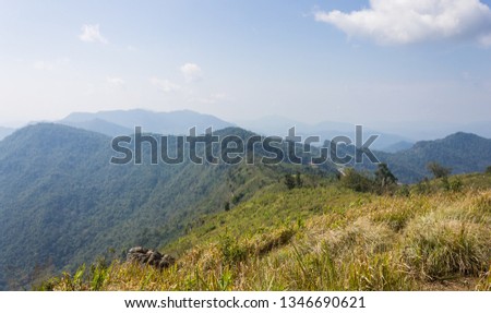 Phu Chi Fa Forest Park view point with Grass Field Green Mountain Sky and Cloud Wide View. Chiang Rai Northern Thailand travel