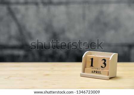 April 13 wooden calendar on vintage wood abstract background. using as background Universal day concept with copy space for your text or design.