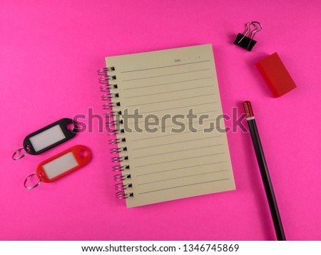 Creative flat lay photo of workspace desk - Top view office desk workplace with notebook, pencil, paperclip, eraser accessories on pink background - Top view with copy space, flat lay photography