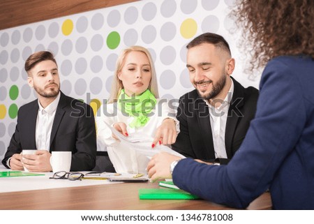 Businesswoman discussing plan with colleagues 