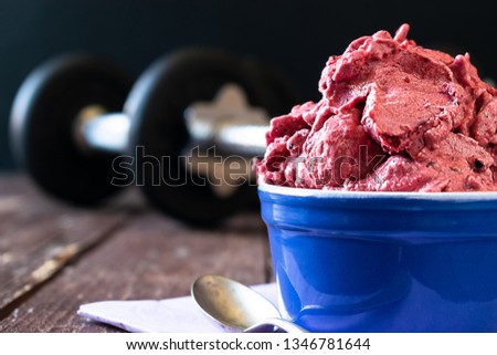 Protein Fluff with berries and egg white, in a dark gym background. Fitness food photography.