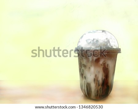 Plastic glass with cold coffee, add milk on a bright background with space for adding pictures and text.