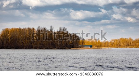 Little house close to the Dnieper river in Kiev, Ukraine, at the beginning of spring, under a cloudy sky