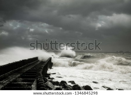 Breaking the waves. Breakwater at Vlissingen harbour, The Netherlands  in upcoming storm.