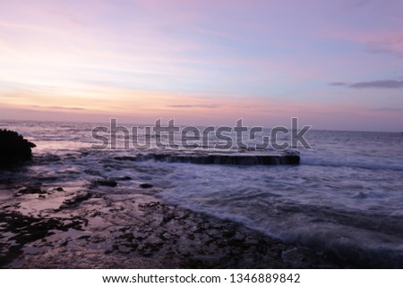 the beautiful beach and moss clinging to small caves at the sunrise