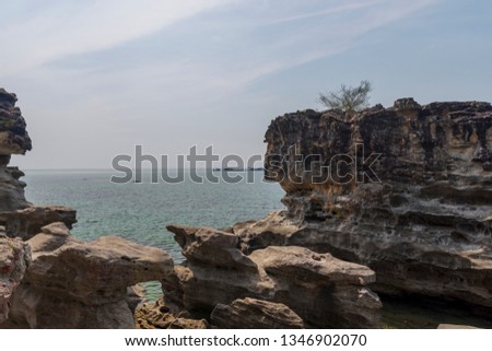 Eroded volcanic cliffs on seashore with sea and horizon in background, picture from Phu Quoc Island Vietnam.