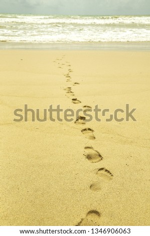 Footprints in the sand at the sea