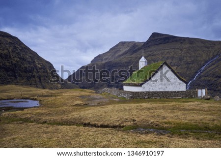 Mediaeval church with grass or turf roof in village Saksun or danish Saksen near the northwest coast of the Faroese island of Streymoy, in Sunda Municipality. Picture is taken in cloudy spring morning