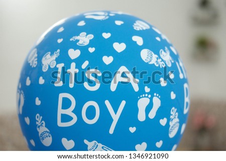'its a boy' written on a baby shower blue balloon