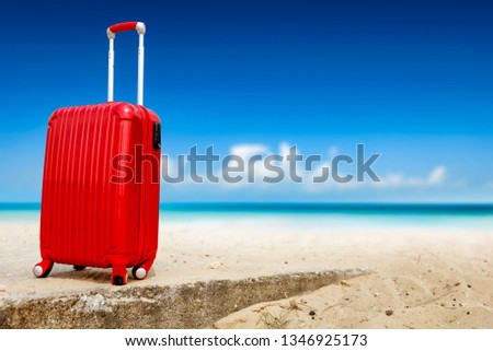 Red suitcase on beach and sea landscape. Free space for your decoration. Summer time. 