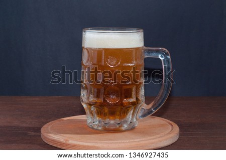 mug of beer on dark background