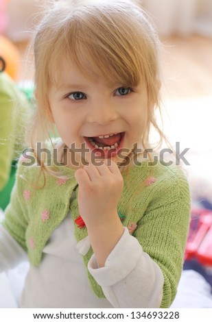 Curious smiling baby girl showing teeth