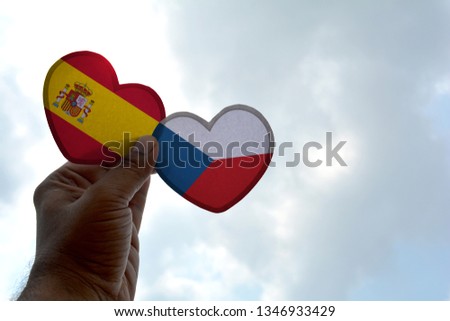 Hand holds a heart Shape Spain and Czech Republic flag, love between two countries
