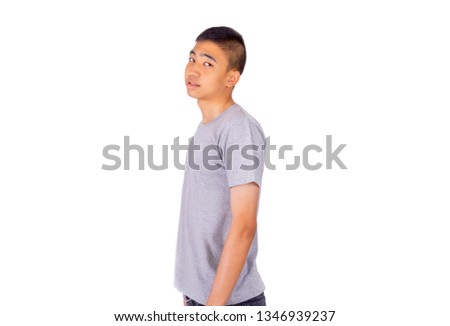 The side view of Thai Thai boy in gray t-shirt peeks 