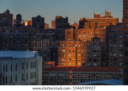 Brick buildings of New York in the rays of sunlight and on the blue sky background