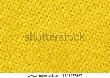 Texture, bright yellow knitted jersey close-up. Blank wool background for layouts.


