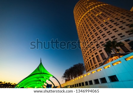 Riverwalk shelter by a skyscraper in downtown Tampa at night. Florida, USA