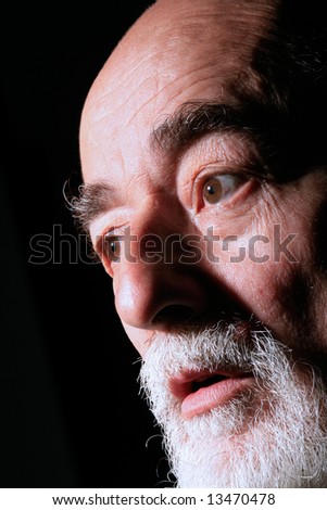 portrait of a shocked senior man who is looking