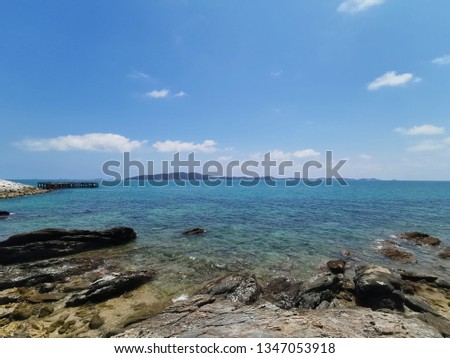beautiful view from the cliff of mountain to the ocean with blue sky and clouds