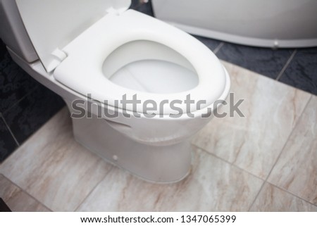 Toilet bowl in modern bathroom interior 