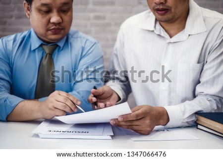Two male lawyer discussing with contract papers and wooden gavel on tabel in courtroom. justice and law ,attorney, court judge, concept