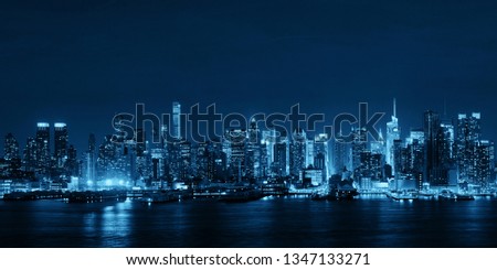 Midtown skyline over Hudson River panorama in New York City with skyscrapers at night