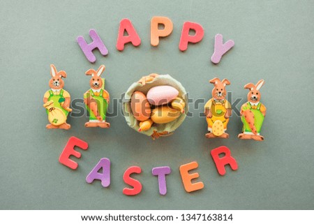 Creative picture with bunnies, chickens, eggs in a basket and the inscription Happy Easter. Decorative concept