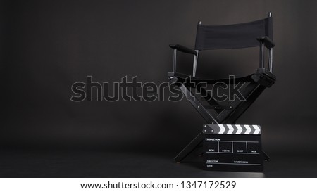 Clapperboard or movie slate with director chair use in video production or movie and cinema industry. It's black color. Royalty-Free Stock Photo #1347172529